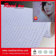 Fabric base microprismatic reflective sheeting for advertising